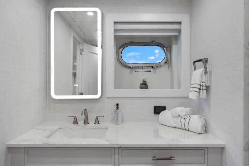 Slide: The Image of Luxurious yacht bathroom with modern fixtures, illuminated mirror, and ocean-view porthole. Mengi Yay 115 MY, 2011. - 83