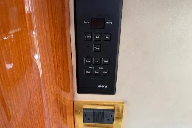 Slide: The Image of Control panel and outlet on 2000 Sea Ray 410 Express Cruiser yacht interior. - 11