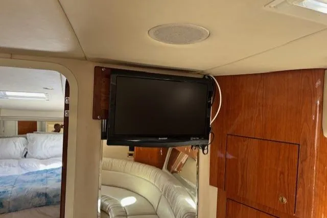 Slide: The Image of Interior of 2000 Sea Ray 410 Express Cruiser with TV and wood paneling. - 12