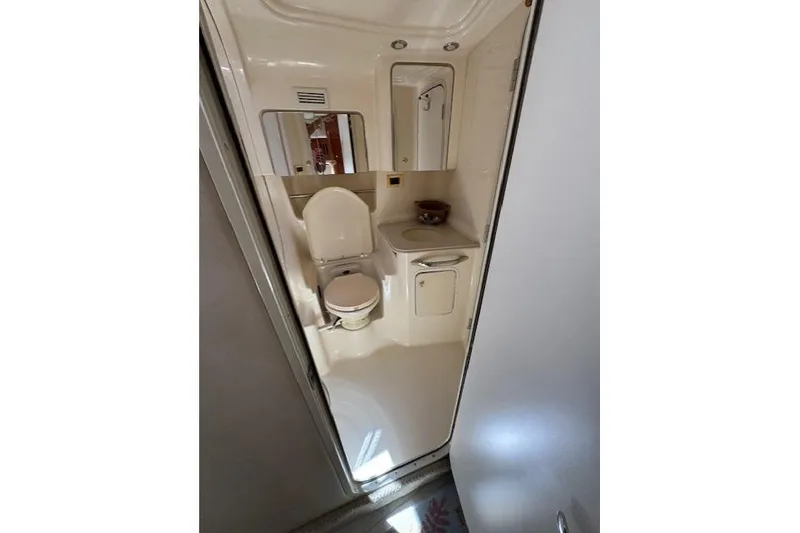 Slide: The Image of Bathroom interior of 2000 Sea Ray 410 Express Cruiser, featuring toilet and sink. - 16