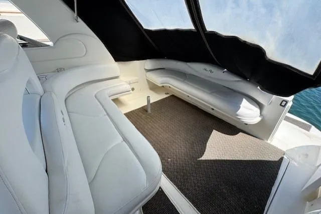 Slide: The Image of Interior of 2000 Sea Ray 410 Express Cruiser with white seating and carpeted floor. - 19