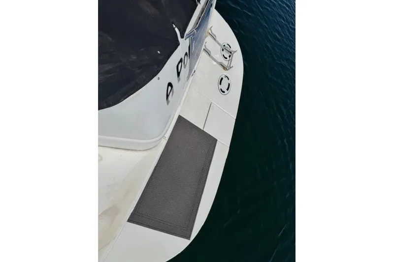 Slide: The Image of 2000 Sea Ray 410 Express Cruiser swim platform on calm water. - 23
