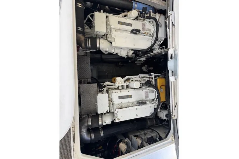 Slide: The Image of Engine compartment of a 2000 Sea Ray 410 Express Cruiser, showcasing dual engines. - 24