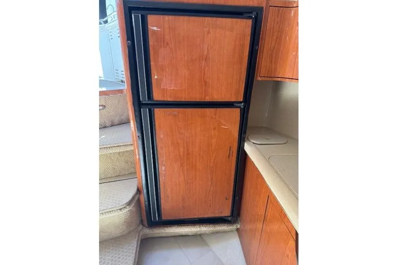 Slide: The Image of Wooden cabinetry and fridge inside 2000 Sea Ray 410 Express Cruiser yacht. - 8