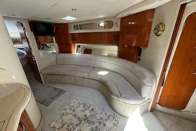 Slide: The Image of Luxurious interior of a 2000 Sea Ray 410 Express Cruiser with plush seating and elegant wood finishes. - 9