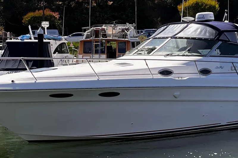 The Image of 1998 Sea Ray 330 Sundancer yacht docked in a marina, side view. - 1
