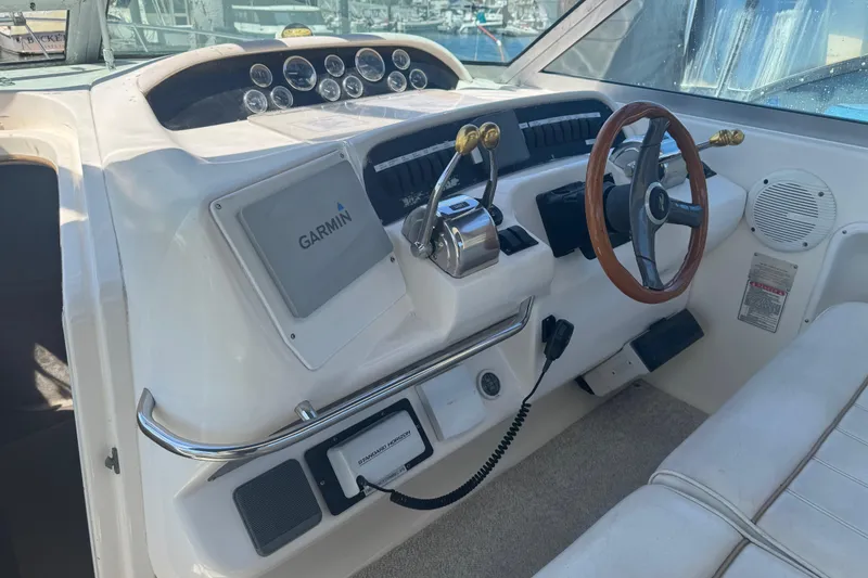 Slide: The Image of 1998 Sea Ray 330 Sundancer helm with Garmin navigation and wood-accented steering wheel. - 10