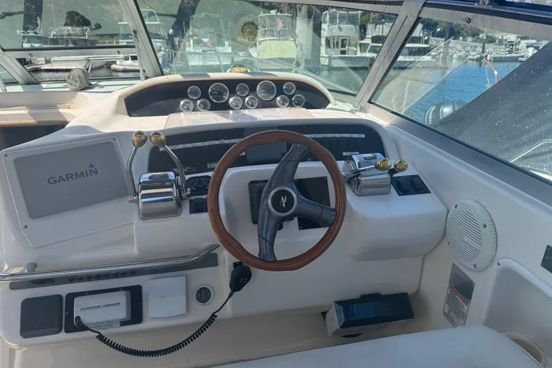 Slide: The Image of 1998 Sea Ray 330 Sundancer helm with Garmin navigation and wood steering wheel. - 12