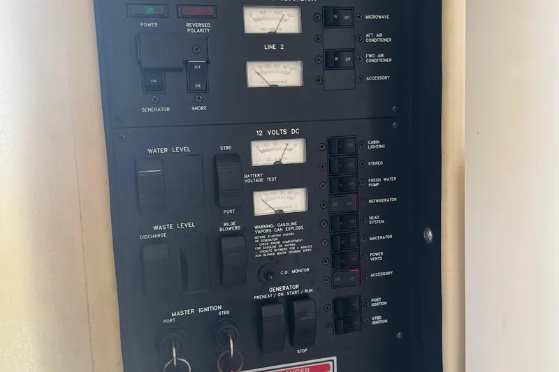 Slide: The Image of Electrical control panel on a 1998 Sea Ray 330 Sundancer boat. - 13