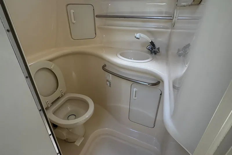 Slide: The Image of Bathroom interior of 1998 Sea Ray 330 Sundancer yacht, featuring toilet and sink. - 14