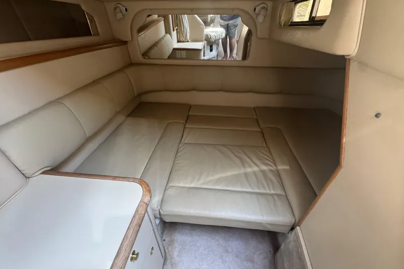Slide: The Image of Interior cabin of 1998 Sea Ray 330 Sundancer with beige leather seating. - 16