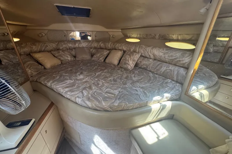 Slide: The Image of 1998 Sea Ray 330 Sundancer cabin with plush bedding and elegant interior design. - 21