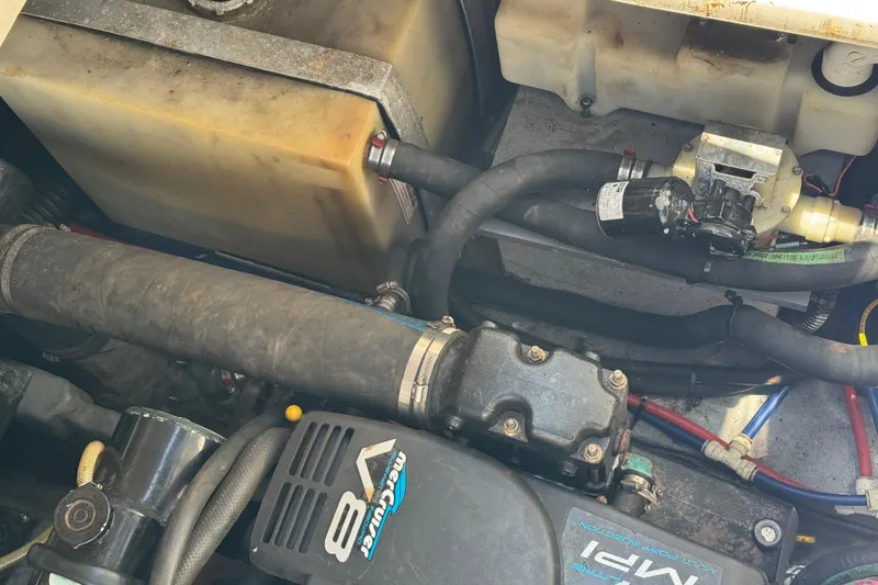 Slide: The Image of Engine compartment of a 1998 Sea Ray 330 Sundancer with visible hoses and components. - 25