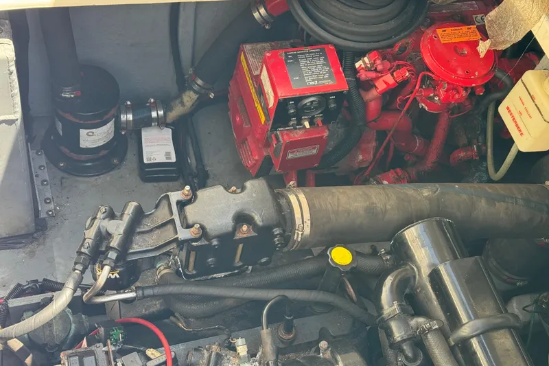 Slide: The Image of Engine compartment of a 1998 Sea Ray 330 Sundancer boat, showing mechanical components. - 26
