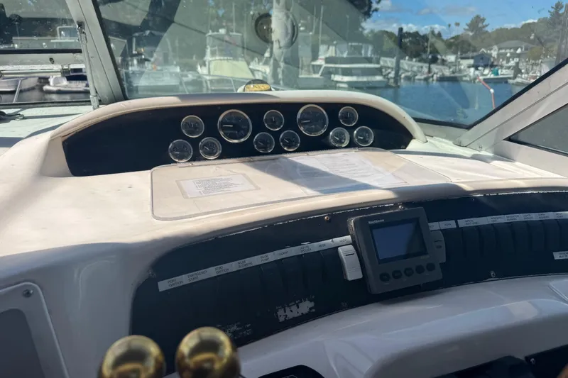 Slide: The Image of Control panel of a 1998 Sea Ray 330 Sundancer boat, featuring gauges and navigation equipment. - 3