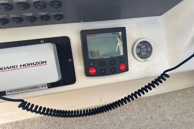Slide: The Image of Control panel of a 1998 Sea Ray 330 Sundancer with navigation and communication devices. - 4
