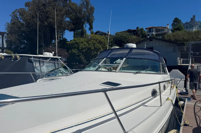 Slide: The Image of 1998 Sea Ray 330 Sundancer docked at marina under clear blue sky. - 5