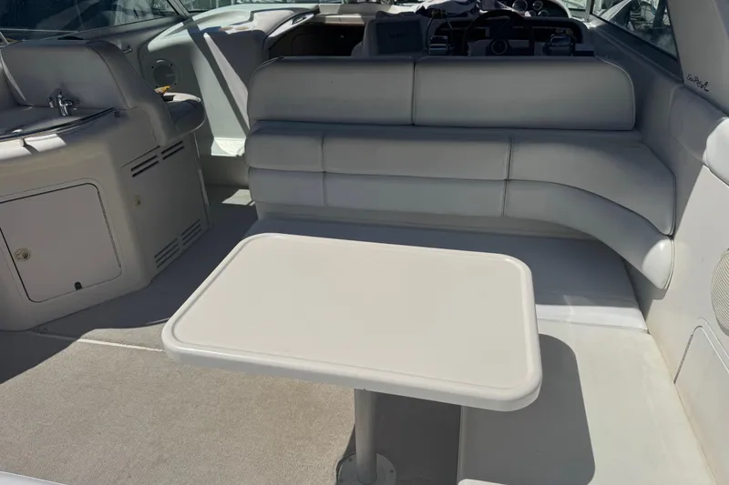 Slide: The Image of 1998 Sea Ray 330 Sundancer interior with seating and table in sunlight. - 7