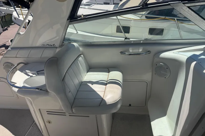Slide: The Image of 1998 Sea Ray 330 Sundancer cockpit with seating and sink, docked at marina. - 9