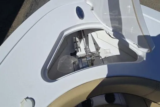 Slide: The Image of 2023 Sportsman Open 242 Center Console anchor storage compartment with open hatch. - 11