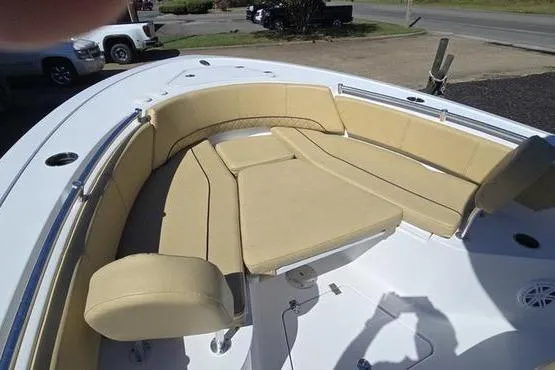 Slide: The Image of 2023 Sportsman Open 242 Center Console boat with tan cushioned seating area. - 13