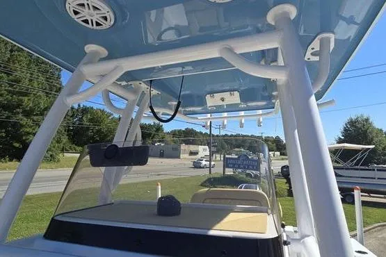 Slide: The Image of 2023 Sportsman Open 242 Center Console boat with T-top and rod holders. - 14