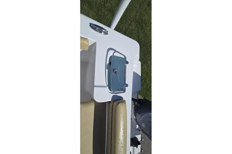 Slide: The Image of 2023 Sportsman Open 242 Center Console boat detail, featuring seating and storage compartment. - 16