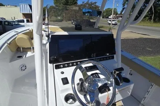 Slide: The Image of 2023 Sportsman Open 242 Center Console boat dashboard with steering wheel and controls. - 17