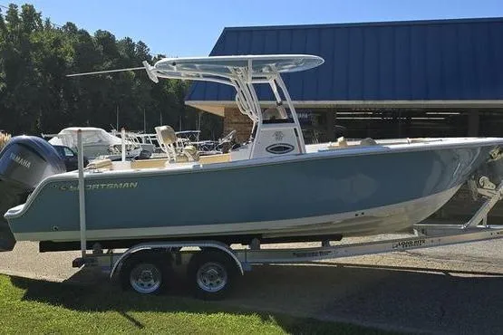Slide: The Image of 2023 Sportsman Open 242 Center Console boat on trailer, parked outdoors. - 3