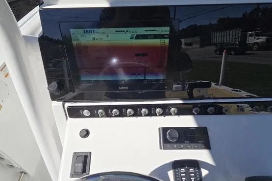 Slide: The Image of 2023 Sportsman Open 242 Center Console dashboard with Garmin display and controls. - 8