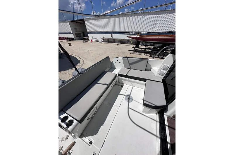 Slide: The Image of 2019 Jeanneau 895 boat interior with cushioned seating and cup holders. - 7