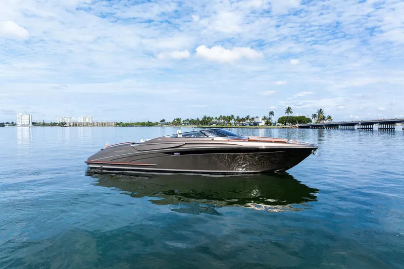Slide: The Image of 2014 Riva Rivarama luxury yacht on calm water under a partly cloudy sky. - 1