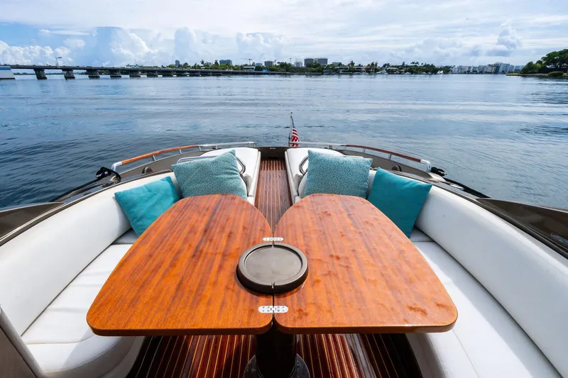 Slide: The Image of Luxurious 2014 Riva Rivarama yacht interior with elegant wooden table and plush cushions. - 10