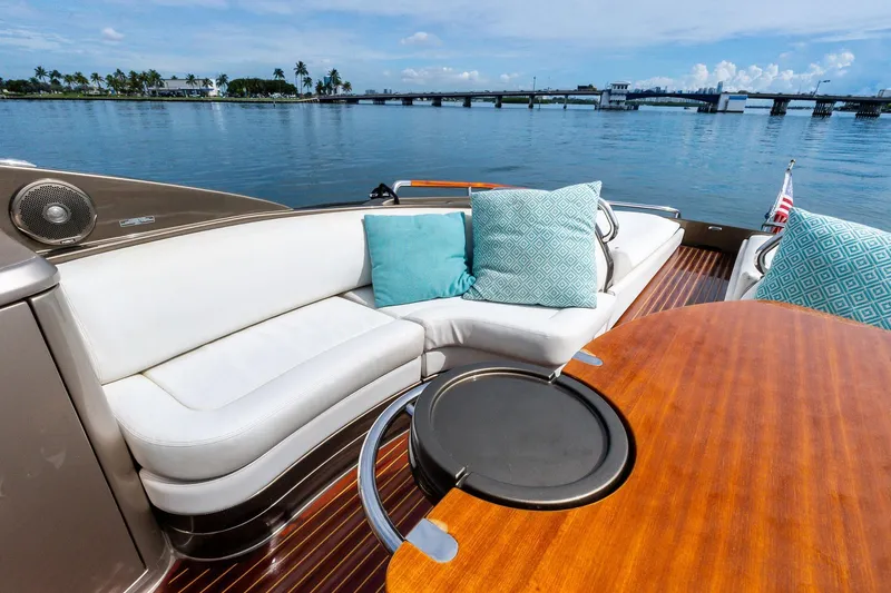 Slide: The Image of Luxurious 2014 Riva Rivarama yacht with elegant seating and scenic waterfront view. - 11