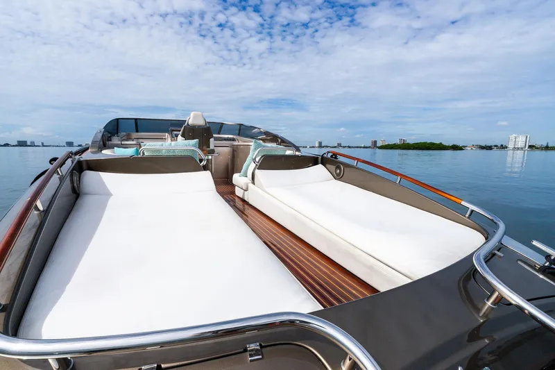 Slide: The Image of Luxurious 2014 Riva Rivarama yacht with sunbeds on calm water, under a clear blue sky. - 12