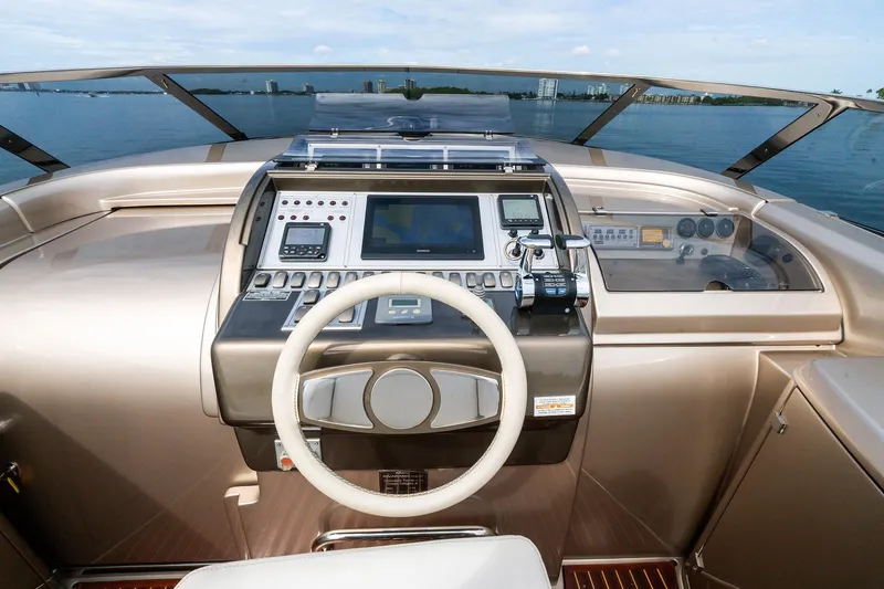 Slide: The Image of 2014 Riva Rivarama yacht dashboard with steering wheel and navigation controls. - 17