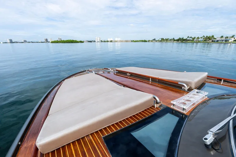 Slide: The Image of Luxurious 2014 Riva Rivarama yacht with sleek deck design on calm waters. - 18