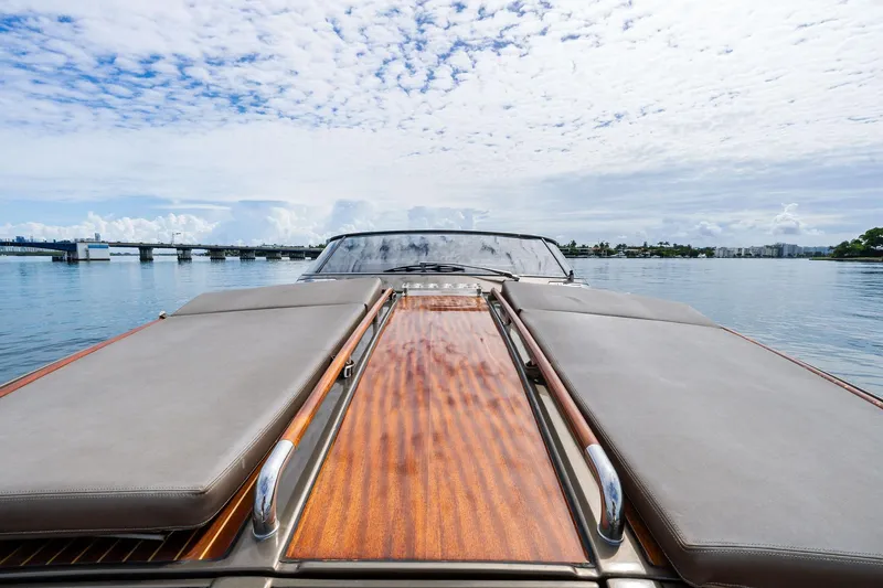 Slide: The Image of 2014 Riva Rivarama luxury yacht on calm water under a partly cloudy sky. - 19