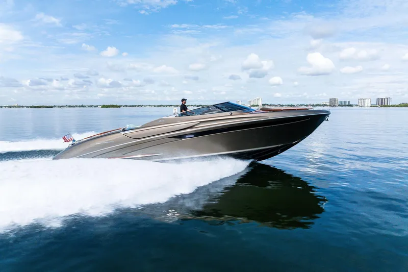 Slide: The Image of 2014 Riva Rivarama luxury yacht cruising on calm waters under a blue sky. - 33