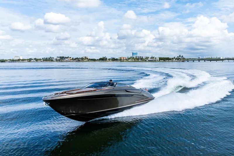 Slide: The Image of 2014 Riva Rivarama luxury yacht cruising on open water under a cloudy sky. - 35