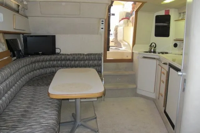 Slide: The Image of Interior of 1992 Sea Ray 370 Express Cruiser with dining area and kitchenette. - 14