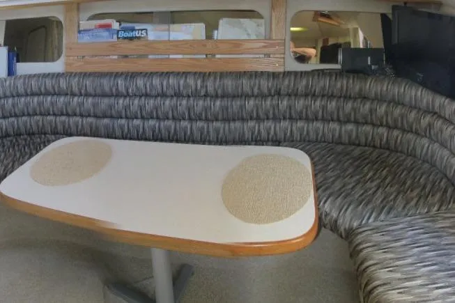 Slide: The Image of Interior of 1992 Sea Ray 370 Express Cruiser with curved seating and table. - 15
