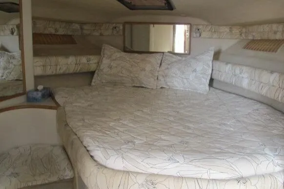 Slide: The Image of 1992 Sea Ray 370 Express Cruiser cabin with floral bedding and mirror. - 16