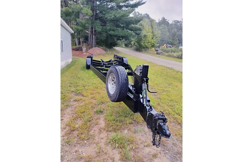 Slide: The Image of Black boat trailer for 1992 Sea Ray 370 Express Cruiser on grassy area. - 20