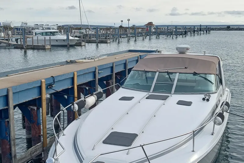 Slide: The Image of 1992 Sea Ray 370 Express Cruiser docked at a marina with calm waters. - 3