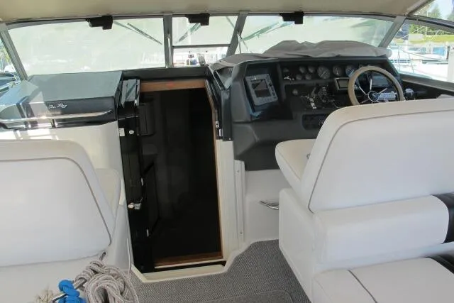 Slide: The Image of 1992 Sea Ray 370 Express Cruiser cockpit with helm, seating, and cabin entrance. - 8