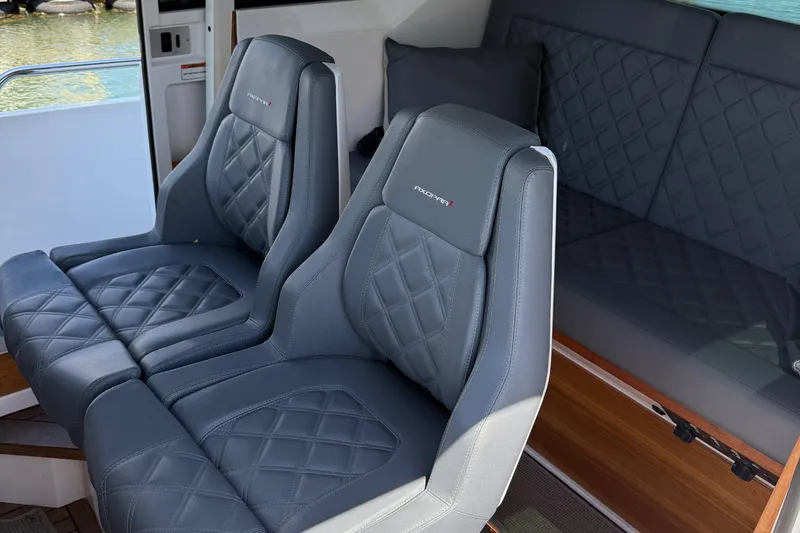 Slide: The Image of 2021 Axopar 28 WetBar helm with dual displays and modern steering wheel. - 12