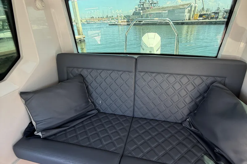 Slide: The Image of Luxurious seating on 2021 Axopar 28 WetBar boat with quilted leather design. - 13