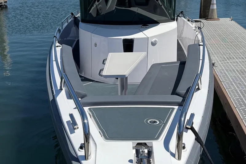 Slide: The Image of 2021 Axopar 28 WetBar boat docked at a marina under clear blue skies. - 3