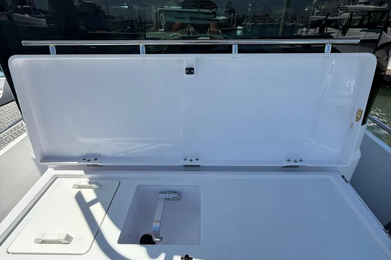 Slide: The Image of 2021 Axopar 28 WetBar boat with Mercury engine docked at marina. - 5